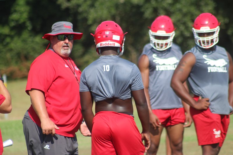 Panther football coach Mark King (left) during a sweltering Aug. 5 MHS practice.