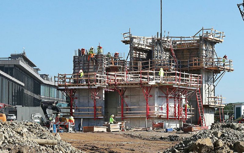 A construction crew works last week on the hotel and events center being built at Oaklawn Racing Casino Resort in Hot Springs.
