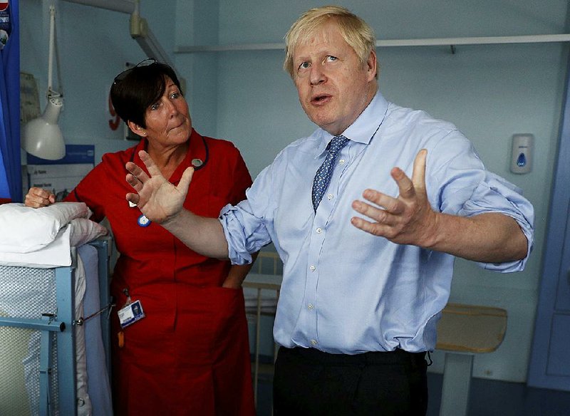 British Prime Minister Boris Johnson, shown Monday at the Royal Cornwall Hospital in Truro, England, said in his letter to European Council President Donald Tusk that the “anti-democratic” Irish-border plan needs to be scrapped if a Brexit deal is to be reached. 