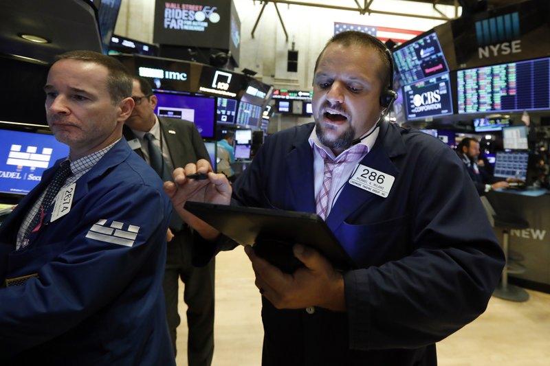  In this Aug. 19, 2019, file photo specialist Stephen Naughton, left, and trader Michael Milano work on the floor of the New York Stock Exchange. Stocks are opening slightly lower on Wall Street on Tuesday, Aug. 20, as major U.S. indexes give back a bit of the ground they won over the previous three days. (AP Photo/Richard Drew, File)