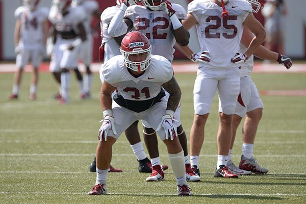 Arkansas linebacker Grant Morgan (31) runs through a drill Tuesday, Aug. 13, 2019, during practice at the university practice facility in Fayetteville. 