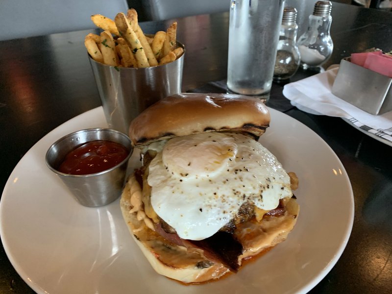 The enormous, spicy Desayuno Burger at Petit &amp; Keet features a patty made of Kobe beef and chorizo, topped with bacon, a chipotle-lime aioli, pepper jack cheese and a fried over-easy egg. Arkansas Democrat-Gazette/Eric E. Harrison