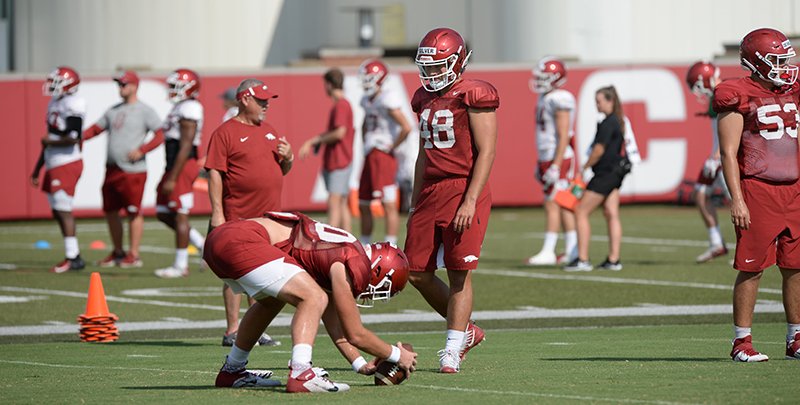 NWA Democrat-Gazette/Andy Shupe PRACTICE SNAPS: Arkansas' Trey Purifoy snaps the ball Tuesday as long snapper Jordan Silver (48) watches during practice at the university's practice facility in Fayetteville.