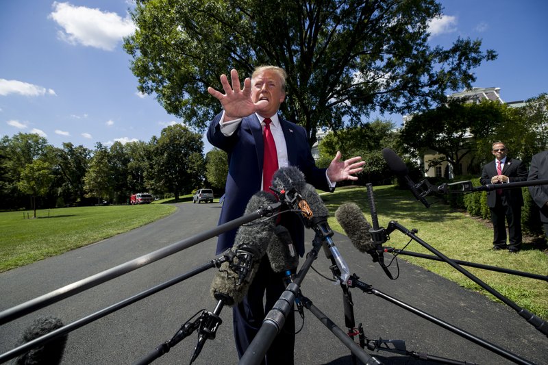 President Donald Trump speaks with reporters before departing on Marine One on the South Lawn of the White House, Wednesday, Aug. 21, 2019, in Washington. Trump is headed to Kentucky. (AP Photo/Alex Brandon)
