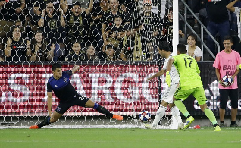 The Associated Press
STRETCH:
Los Angeles FC forward Carlos Vela, center, scores past San Jose Earthquakes goalkeeper Daniel Vega (17) and defender Nick Lima during the first half of Wednesday's match in Los Angeles. 