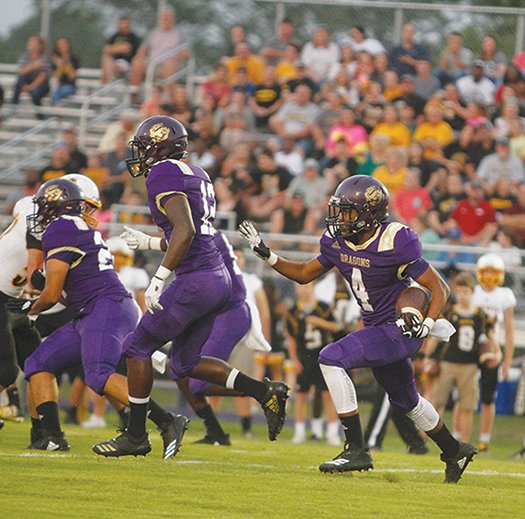 Terrance Armstard/News-Times In this file photo, Junction City running back Jakiron Cook looks for running room during the Dragons' clash against Harmony Grove at Junction City during the 2018 season. The Dragons and Hornets will open the season on Aug. 30 in a battle of teams ranked No. 1 by Hooten’s in 2A and 3A respectively.