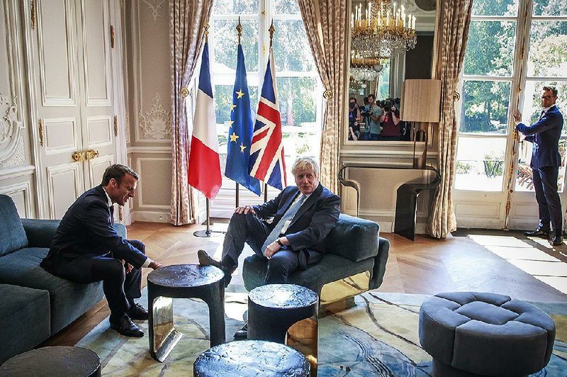 French President Emmanuel Macron (left) meets with British Prime Minister Boris Johnson at  the  Elysee Palace in Paris on Thursday. Macron sounded a note of skepticism on the chances of a new agreement on Britain’s exit from the European Union. 