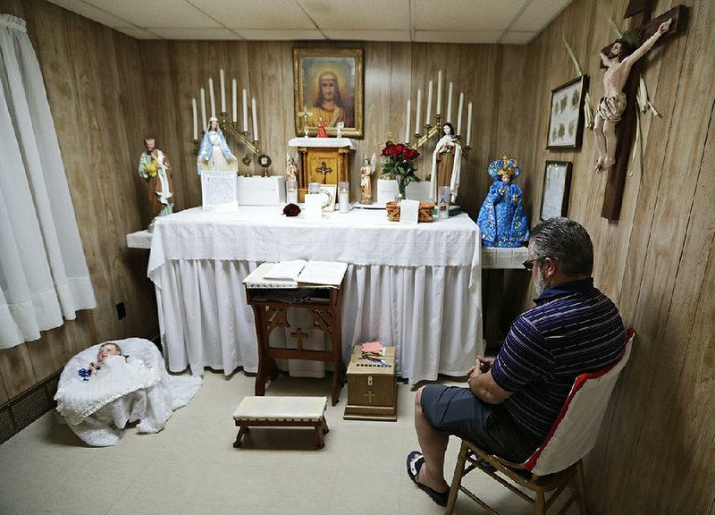 Ron Sattler sits in the chair where Rhoda Wise said she was visited by Jesus Christ in front of the altar in Canton, Ohio. Eighty years after Rhoda Wise first claimed she was a receiver of Christian miracles, people are still visiting her Ohio home to see for themselves. 