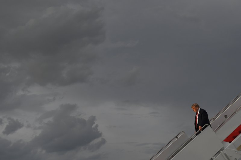 President Donald Trump walks down the steps of Air Force One at Andrews Air Force Base in Md., Wednesday, Aug. 21, 2019.  (AP Photo/Susan Walsh)