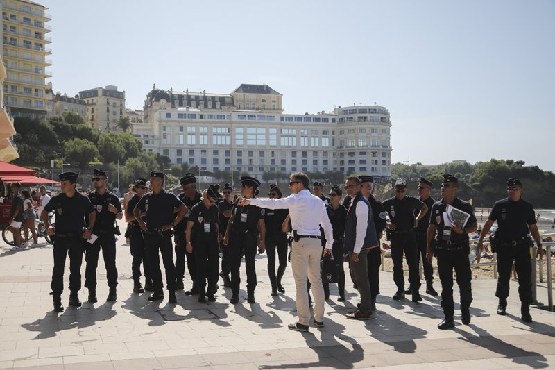 French police officers get instructions in front of the Le Bellevue at the beach promenade ahead of the upcoming G7 Summit, in Biarritz, France, Thursday, Aug. 22, 2019. The G7 Summit will host the heads of countries with advanced economies from United States, Britain, Canada, Germany, Italy, Japan and France and will be held in Biarritz between the 24th and 26th of August. (AP Photo/Markus Schreiber)