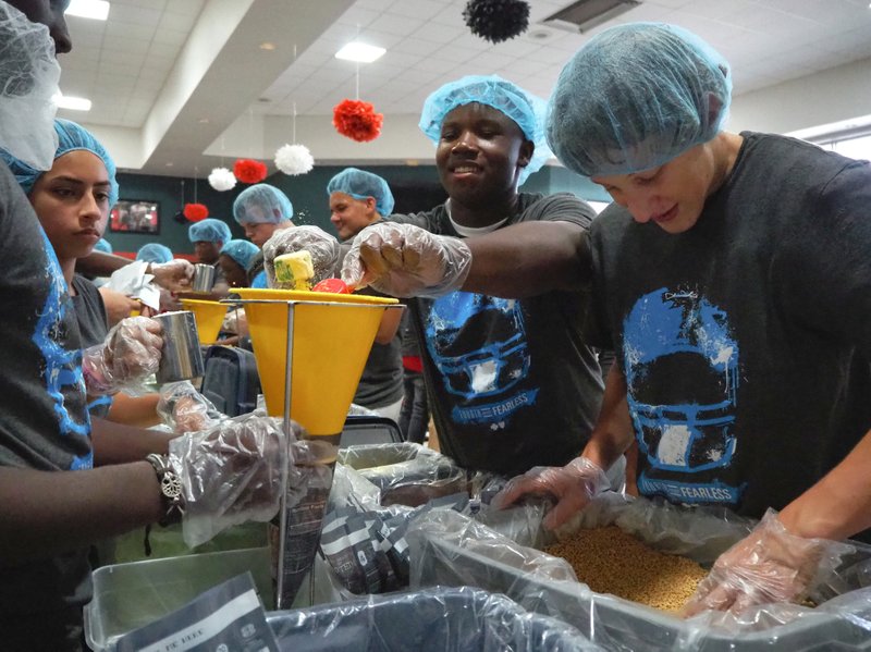 Members of the Magnolia Panther football team, cheer squad, and drill team frantically pack 40,000 meals in 1.5 hours Thursday, Aug. 23. The meals will now be issued to four Columbia County charities. 