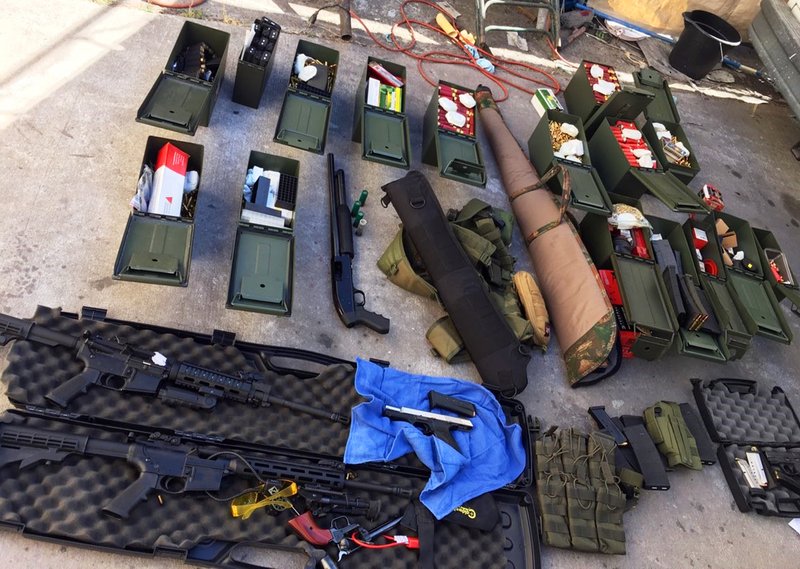 This undated photo released Wednesday, Aug. 21, 2019 by the Long Beach, Calif., Police Department shows weapons and ammunition seized from a cook at a Los Angeles-area hotel who allegedly threatened a mass shooting. Authorities say he had guns and hundreds of rounds of ammunition at his home. Rodolfo Montoya was arrested Tuesday, Aug. 20, a day after allegedly telling a co-worker at the Long Beach Marriott he planned to shoot fellow workers and others. (Long Beach Police Department via AP)