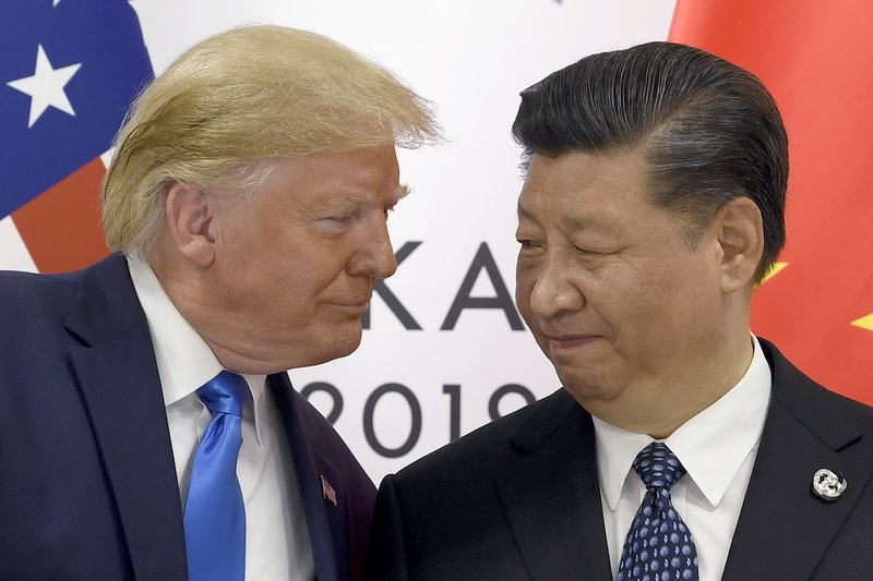 FILE - In this June 29, 2019, file photo, President Donald Trump, left, meets with Chinese President Xi Jinping during a meeting on the sidelines of the G-20 summit in Osaka, Japan. China has announced it will raise tariffs on $75 billion of U.S. products in retaliation for President Donald Trump's planned Sept. 1 duty increase in a war over trade and technology policy. (AP Photo/Susan Walsh, File)

