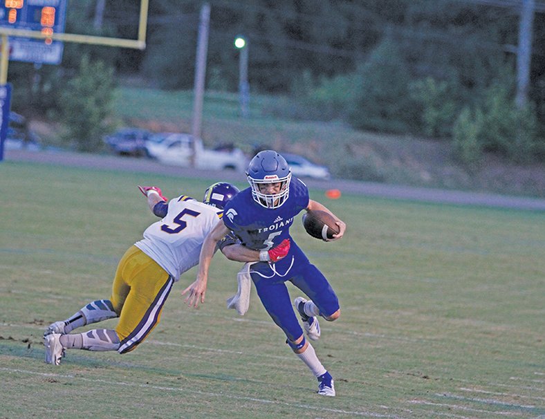 Terrance Armstard/News-Times In this file photo, Parkers Chapel's Caleb Jacobs tries to break a tackle during the Trojans' contest against Mayflower at Victor Nipper Stadium during the 2018 season. The Trojans are hoping to reach the playoffs for the seventh straight year in 2019. Parkers Chapel will host Glenbrook (La.) in their season opener.