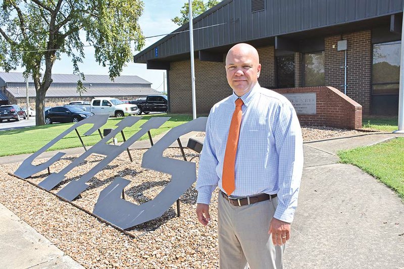 Tim Smith stands outside Clinton High School, where he took over July 1 as principal. Smith said his goal is to create a brand for the school, based on love, respect and service. He asked teachers during in-service training before school started to perform random acts of kindness and video them. “What I believe also is, this is a people business — it’s all about relationships,” he said.