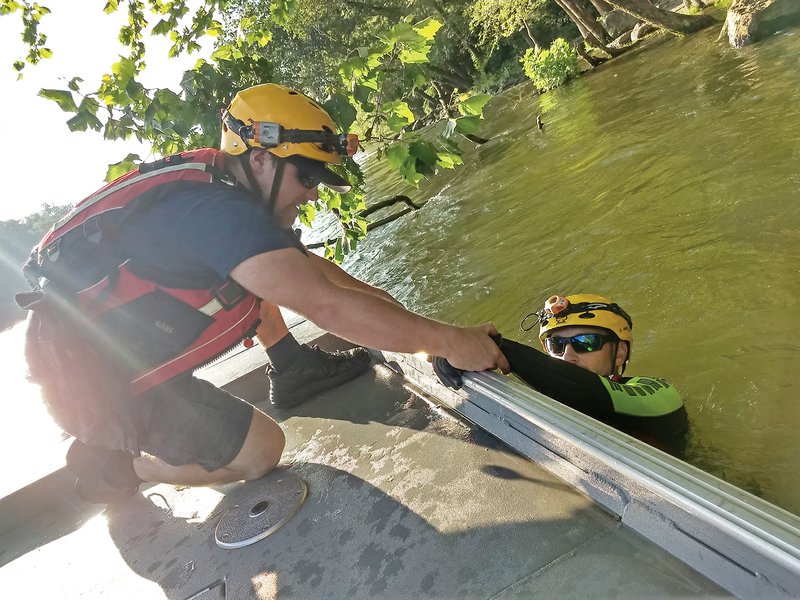 Rescue trainee Tanner Neighbors tries to lift a rescue instructor, who is pretending to be an accident victim, into the rescue boat. The right angles, not strength, make these types of maneuvers a success. The No. 1 rule for water rescuers is to never get into the water.