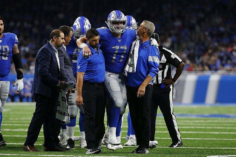 Detroit Lions center Frank Ragnow (Arkansas Razorbacks) is helped off the field by medical staff in the first half of the Lions’ 24-20 loss to the Buffalo Bills. Ragnow was injured on a running play and did not return to the game.