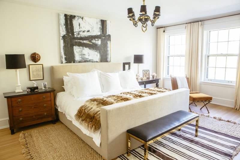 This undated photo shows a master bedroom designed by Lauren Buxbaum Gordon. The natural fiber rug adds warmth and softness around the bed, while a smaller throw rug adds a touch of bold pattern. (Heather Talbert/Nate Berkus Associates/Lauren Buxbaum Gordon via AP)