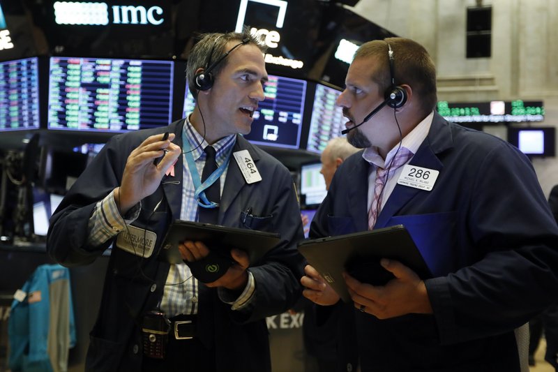 FILE - In this Aug. 19, 2019, file photo traders Gregory Rowe, left, and Michael Milano work on the floor of the New York Stock Exchange. The U.S. stock market opens at 9:30 a.m. EDT on Friday, Aug. 23. (AP Photo/Richard Drew, File)