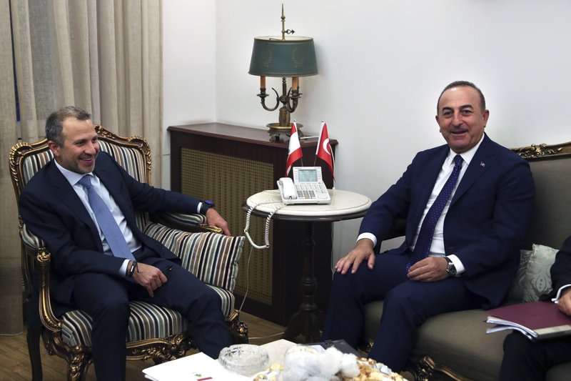 Lebanese Foreign Minister Gibran Bassil, left, meets with his Turkish counterpart Mevlut Cavusoglu, at the Lebanese foreign ministry, in Beirut, Lebanon, Friday, Aug. 23, 2019. (AP Photo/Bilal Hussein)