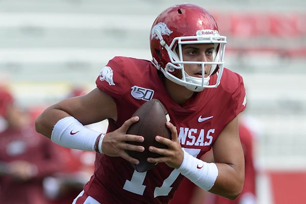 Arkansas quarterback Nick Starkel carries the ball Saturday, Aug. 24, 2019, during practice in Razorback Stadium in Fayetteville. 