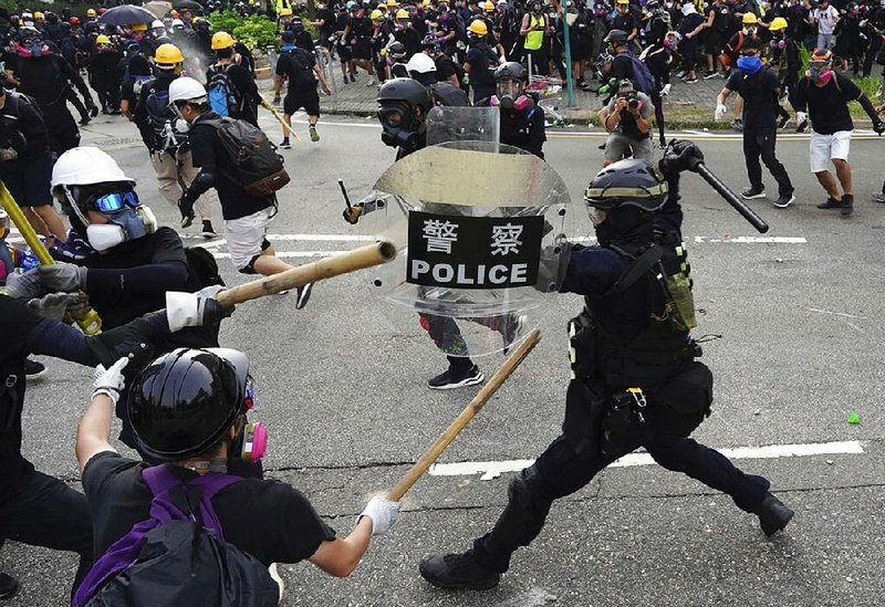 Police and demonstrators clash during Saturday’s protests in Hong Kong.