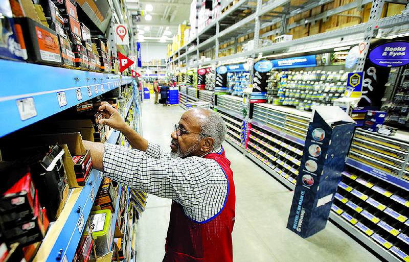 Employee Larry Wardford works at a Lowe’s store in Framingham, Mass. The home-improvement retailer exceeded second-quarter earnings forecast after strong sales in the spring. 