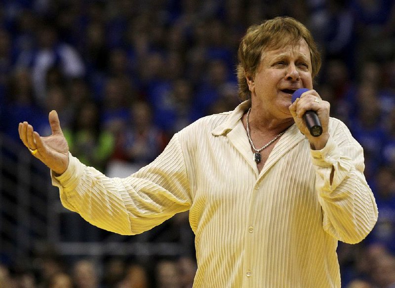 In this Jan. 25, 2010 file photo, Eddie Money sings the national anthem before an NCAA college basketball game between Kansas and Missouri in Lawrence, Kan.