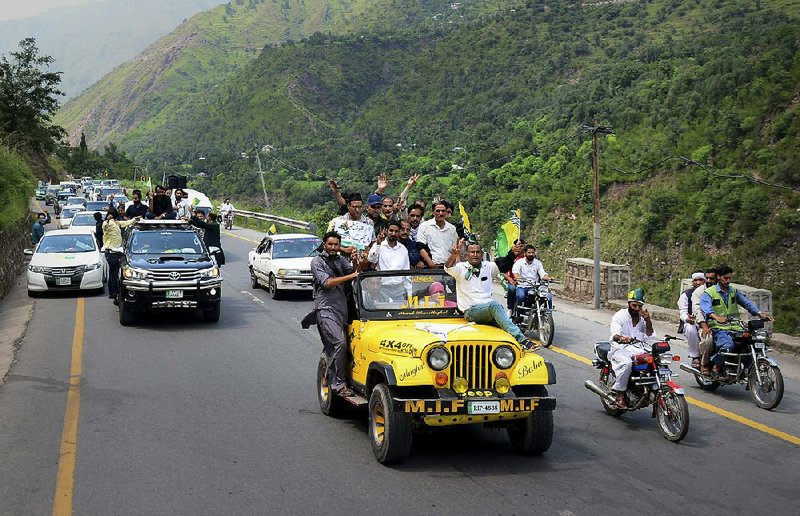 Journalists take part in a rally Saturday in Chinari, a village on the Pakistani side of Kashmir, as they head toward the Line of Control that divides the region. 