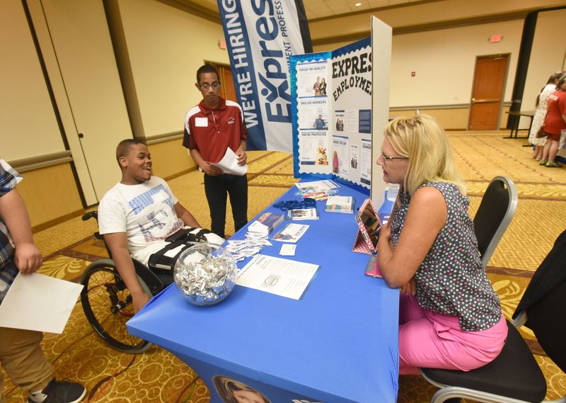 File photo Jumere Richardson (from left) and Jake Smitker chat with Cindy Hoehner of Express Employment Professionals during a job fair hosted by the Arkansas Support Network in Bentonville at Four Points by Sheraton. The group holds job fairs to help people with disabilities find work and educate employers on the benefits of hiring workers with disabilities. The Great Tailgate for Inclusion benefit for Arkansas Support Network will be Aug. 30 at Shiloh Square in Springdale.