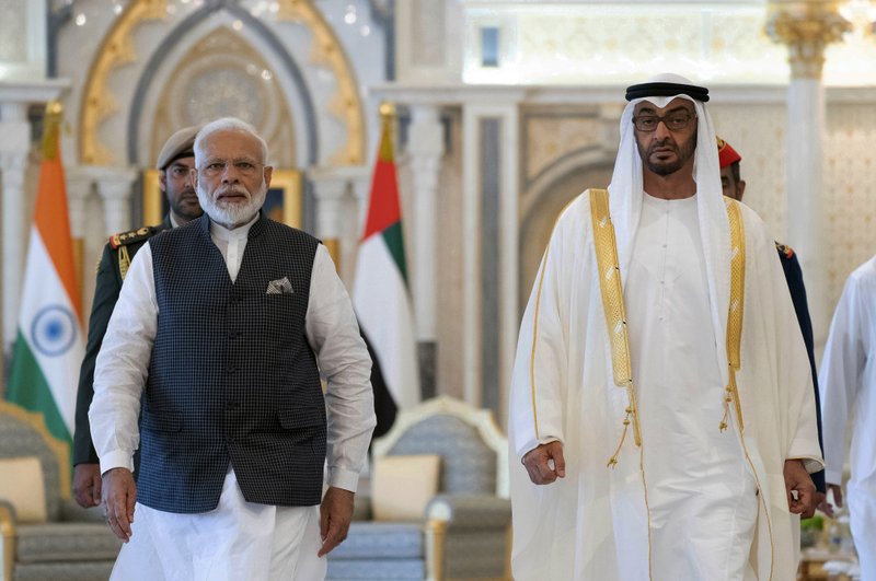 In this photograph made available by the state-run WAM news agency, Indian Prime Minister Narendra Modi, left, walks with Sheikh Mohammed bin Zayed Al Nahyan, right, in Abu Dhabi, United Arab Emirates, Saturday, Aug. 24, 2019. Modi is on a trip to both the United Arab Emirates and Bahrain, reinforcing ties between India and the Gulf Arab nations as he pursues stripping statehood from the disputed Muslim-majority region of Kashmir. (Ryan Carter - Ministry of Presidential Affairs/WAM via AP)