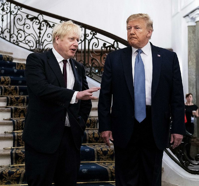 British Prime Minister Boris Johnson (left) and President Donald Trump speak to reporters Sunday before a breakfast meeting on the sidelines of the Group of Seven summit in Biarritz, France. 
