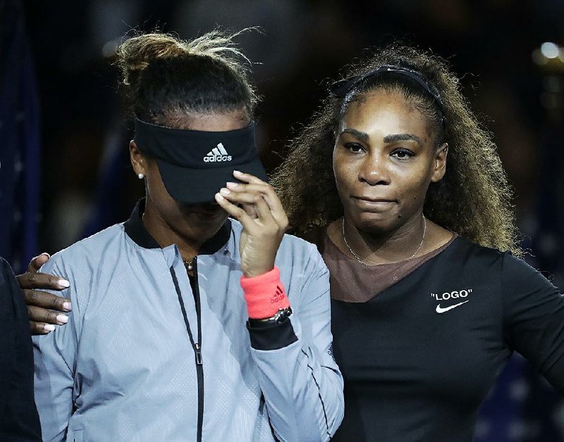 Naomi Osaka, left, of Japan, is hugged by Serena Williams after Osaka defeated Williams in the women's final of the U.S. Open tennis tournament in New York. The tenor of the final between Williams and champion Osaka, whose terrific performance was largely ignored amid the chaos that enveloped Arthur Ashe Stadium, began to shift after chair umpire Carlos Ramos warned Williams for receiving coaching signals.