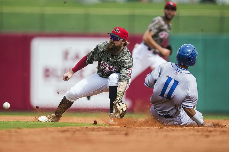 Arkansas Travelers second baseman Jordan Cowan attempts to make a play during Sunday’s 5-2 loss to the Amarillo Sod Poodles at Dickey-Stephens Park in North Little Rock. 