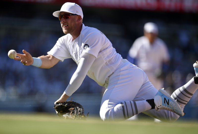 The Associated Press FLIP TOSS: Los Angeles Dodgers first baseman Matt Beaty attempts to throw to first after misplaying a grounder by New York Yankees' Brett Gardner during the ninth inning of a Saturday's game in Los Angeles. The Dodgers won 2-1.