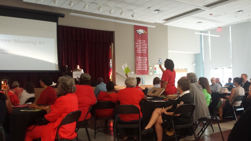 Protesters voice concern during a public meeting Monday about the future of the state-controlled Little Rock School District.