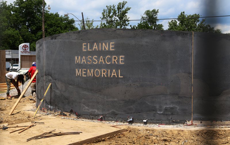 FILE - In this June 15, 2019, file photo, men work near a monument under construction honoring victims of the Elaine Massacre that sits across from the Phillips County courthouse in Helena. (AP Photo/Noreen Nasir, File)

