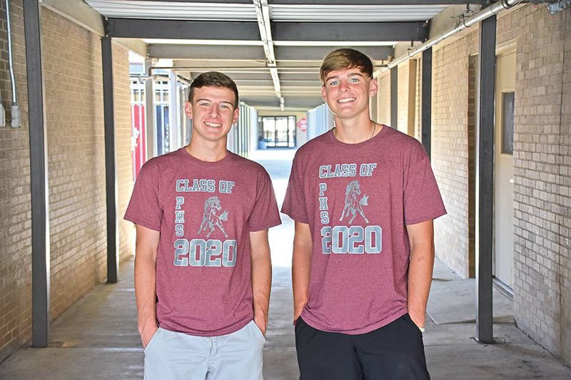 Ryan Standridge, left, and his twin brother, Reid, stand under the covered walkway at Perryville High School. Reid, a three-sport athlete, is quarterback of the football team, and Ryan plays baseball and basketball. The brothers have a 3.8 GPA and participate in school clubs together.