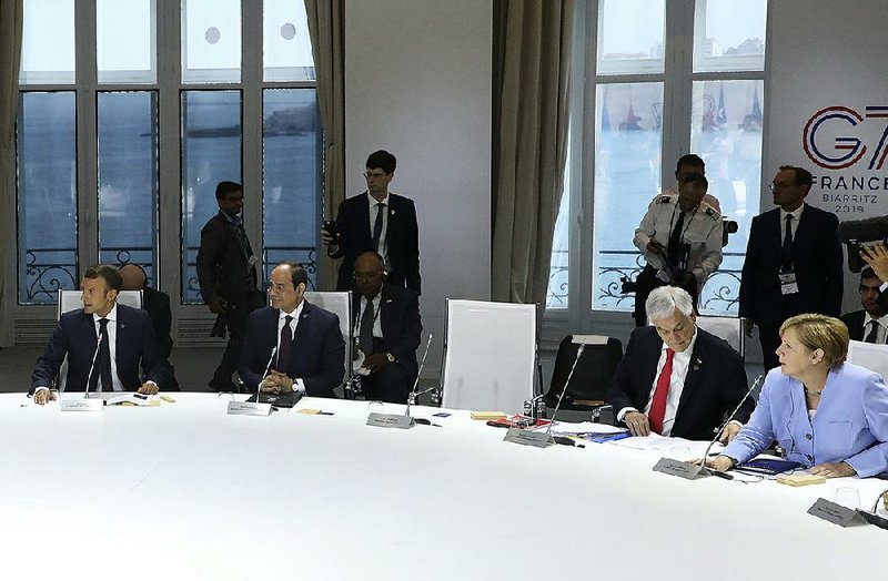 French President Emmanuel Macron, Egyptian President and Chairman of the African Union Abdel Fattah al-Sissi, Chilean President Sebastian Pinera and German Chancellor Angela Merkel attend a work session Monday focused on climate in Biarritz, southwestern France, on the third day of the annual G7 Summit. For more photos, see arkansasonline.com/827summit/ 