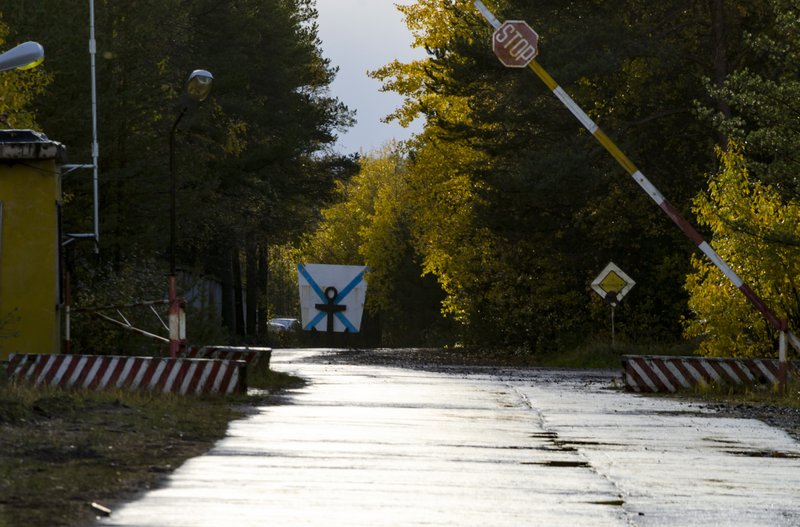 FILE - This Sunday, Oct. 7, 2018 file photo, shows an entrance to &quot;The State Central Navy Testing Range&quot; near the village of Nyonoksa, northwestern Russia. The Aug. 8, 2019, explosion of a rocket engine at the Russian navy's testing range just outside Nyonoksa led to a brief spike in radiation levels and raised new questions about prospective Russian weapons. Over Russian 100 medical workers who helped treat victims of a recent mysterious explosion at a military testing range have undergone checks and one man has been found with a trace of radiation, officials said Friday Aug. 23, 2019. (AP Photo/Sergei Yakovlev, File)