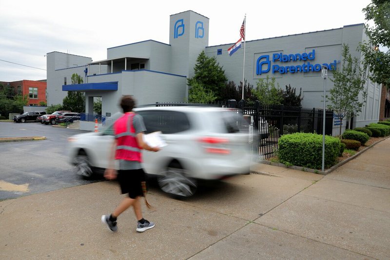 FILE - In this June 21, 2019, file photo, a motorist enters Planned Parenthood of the St. Louis Region and Southwest Missouri. A new Missouri ban on abortions at or after eight weeks of pregnancy won't take effect on August 28 after a federal judge temporarily blocked it from being implemented. U.S. District Judge Howard Sachs put a pause on the law as a legal challenge against it plays out in court. Planned Parenthood and the American Civil Liberties Union of Missouri filed the lawsuit, arguing that the law is unconstitutional and goes against the landmark 1973 U.S. Supreme Court Roe v. Wade ruling that legalized abortion nationwide. (Christian Gooden/St. Louis Post-Dispatch via AP, File)