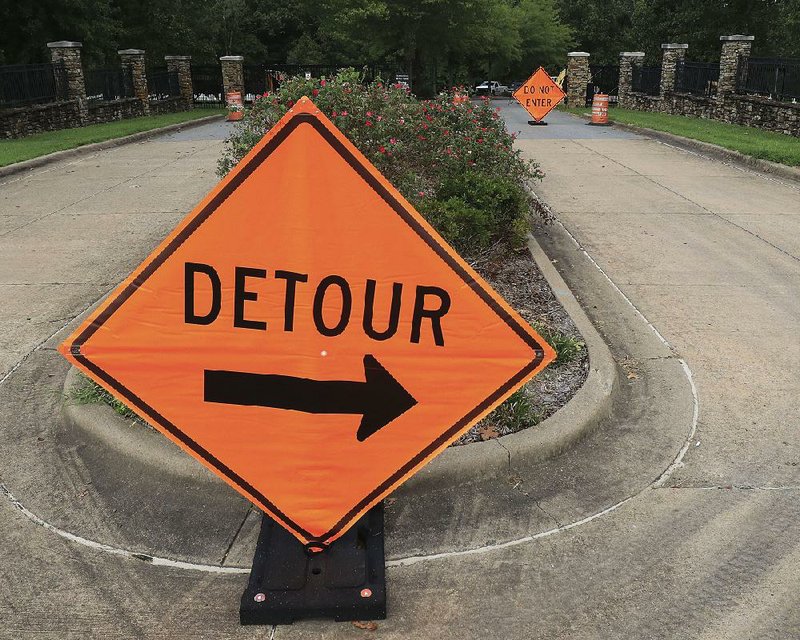 Signs at the main entrance of the Arkansas State Veterans Cemetery in North Little Rock point visitors to a temporary entrance Tuesday as renovations at the cemetery continue. Some sections of the cemetery are temporarily closed. 