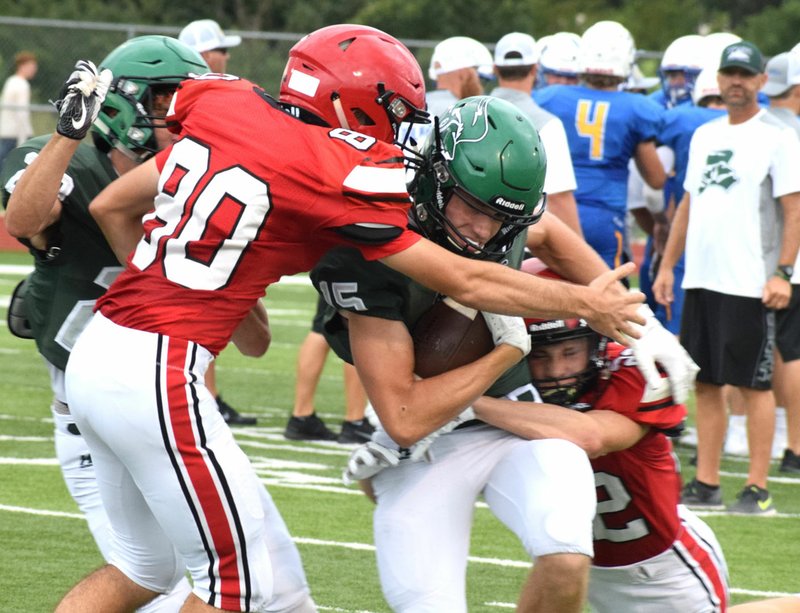 RICK PECK/SPECIAL TO MCDONALD COUNTY PRESS McDonald County defensive backs Keegan Driscoll (22) and Levi Malone (80) stop Mount Vernon's Rafe Darter during a jamboree held on Aug. 23 at Mount Vernon High School.