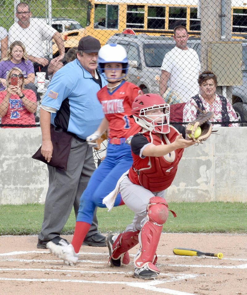 RICK PECK/SPECIAL TO MCDONALD COUNTY PRESS McDonald County freshman catcher Reagan Myrick stretches in vain for a throw to force an East Newton runner at the plate during the Lady Mustangs' 6-4 win on Aug. 27 at MCHS.