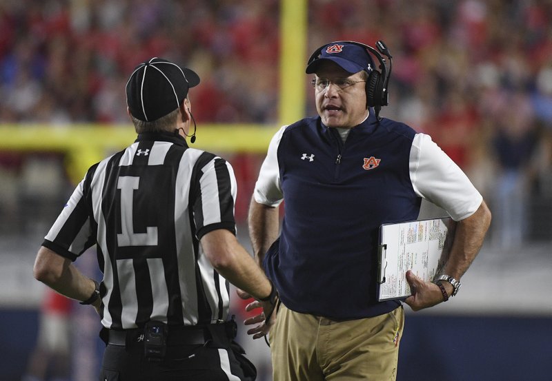 Auburn head coach Gus Malzahn talks with a referee during the first half of an NCAA college football game against Mississippi in Oxford, Miss., Saturday, Oct. 29, 2016. (AP Photo/Thomas Graning)