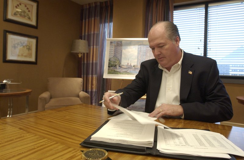 In this 2010 photo, Bill Schwyhart goes over budget figures for the Northwest Arkanas Regional Airport in a Pinnacle Tower conference room in Rogers.