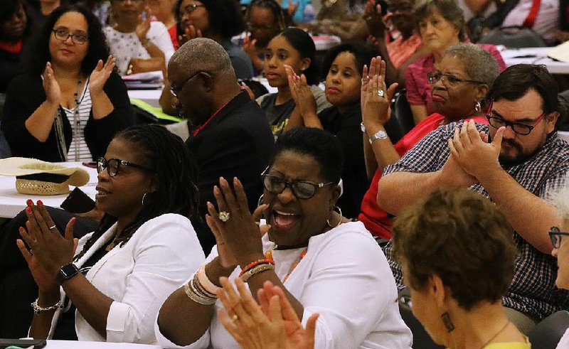 Members of the audience cheer Thursday evening at Longley Baptist Church on Geyer Springs Road after a speaker addressed the state Board of Education on the future of the Little Rock School District.