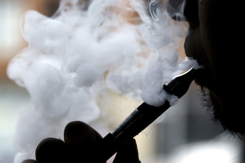FILE — A smoker fires up an electronic cigarette in Chicago in 2014.