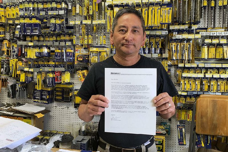 Albert Chow, owner of Great Wall Hardware in San Francisco, shows a letter a supplier sent in May to notify him that prices would increase because of tariffs on Chinese products. 