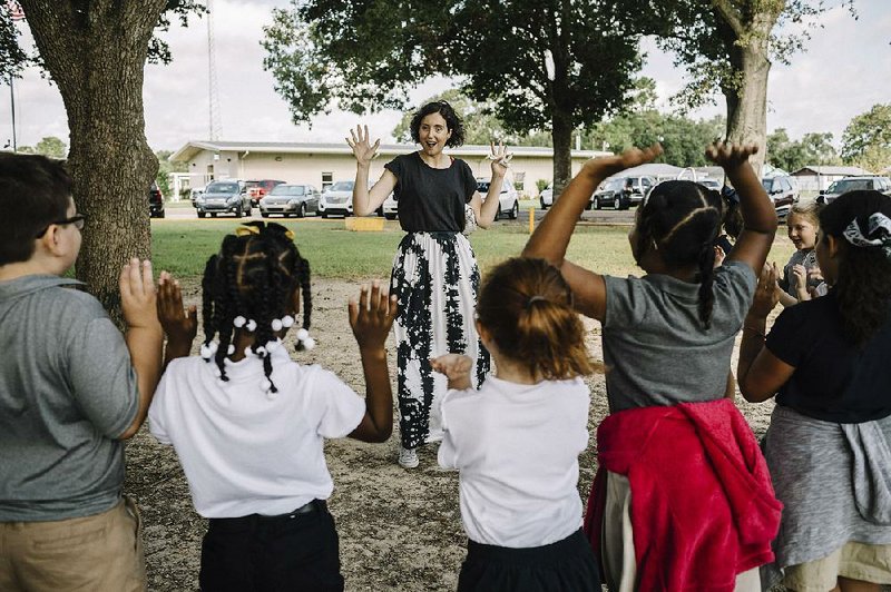 Alice Renard, who moved from France to teach French, leads her class in a game at Mamou Elementary in Mamou, La., in early August. Renard is one of about 65 French-speaking teachers imported by Louisiana this year for its growing ranks of French immersion schools. 